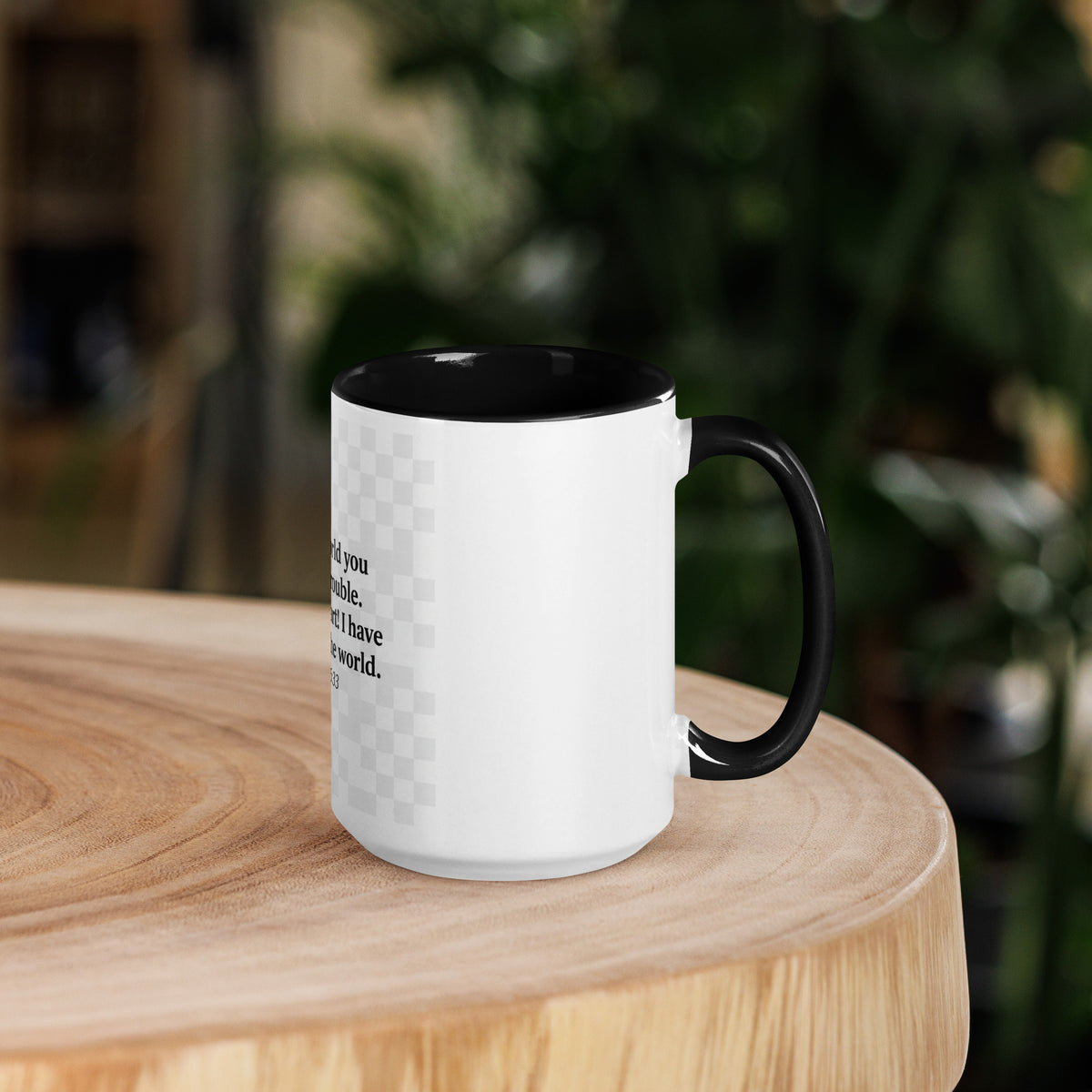 White ceramic mug with black interior, 15 oz, featuring the Faith "I Have Overcome the World" message, from Tristan's Outlet.