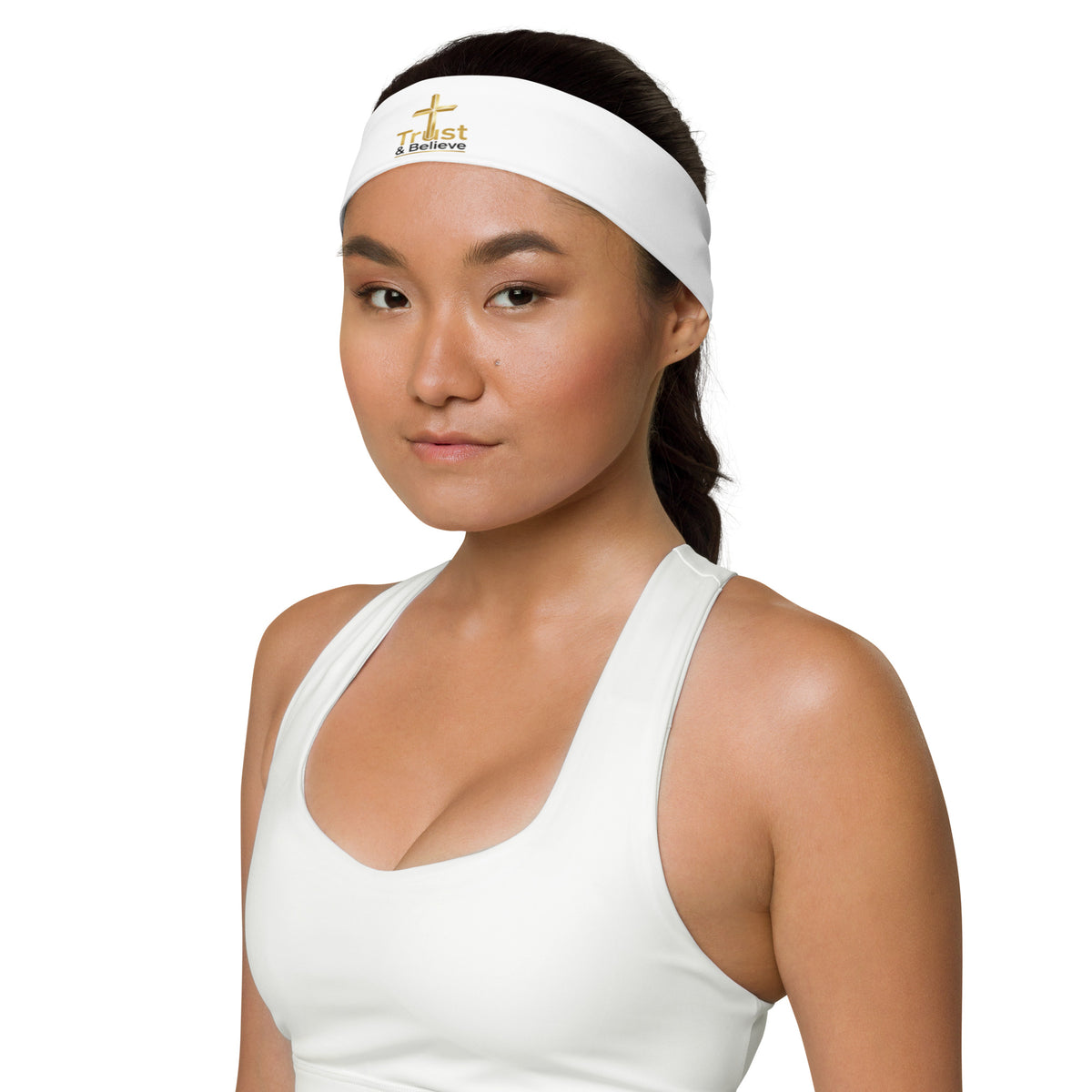 White Trust & Believe headband by Tristan's Outlet with colorful all-over print, shown from a front-left angle.
