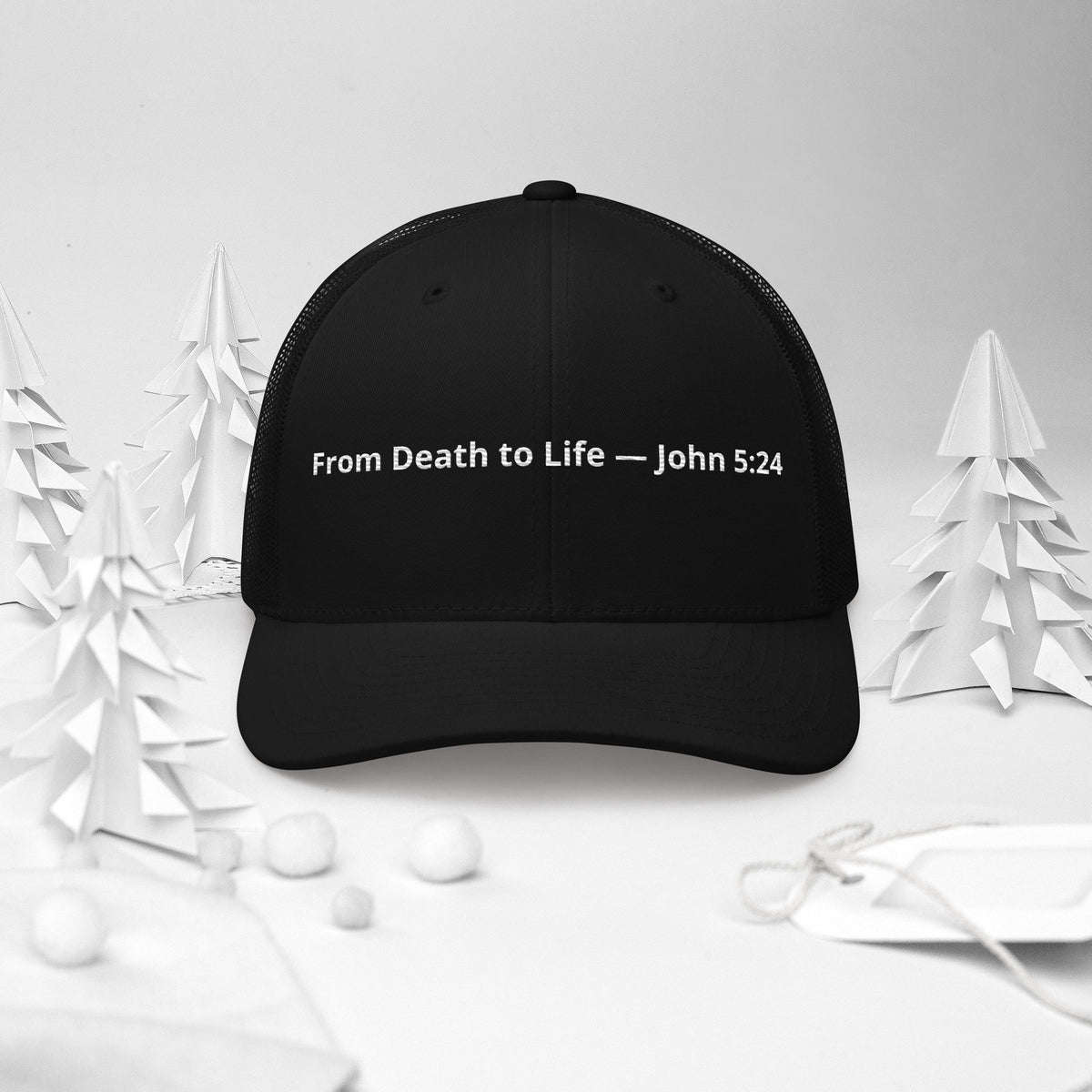 Black trucker hat featuring "From Death to Life" and John 5:24 scripture, with a retro style and mesh back from Tristan's Outlet.
