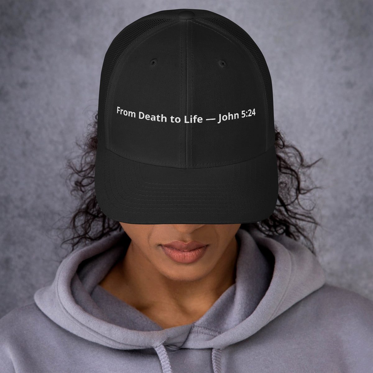 Black retro trucker hat with "From Death to Life" and John 5:24 scripture, featuring a mesh back and curved brim.