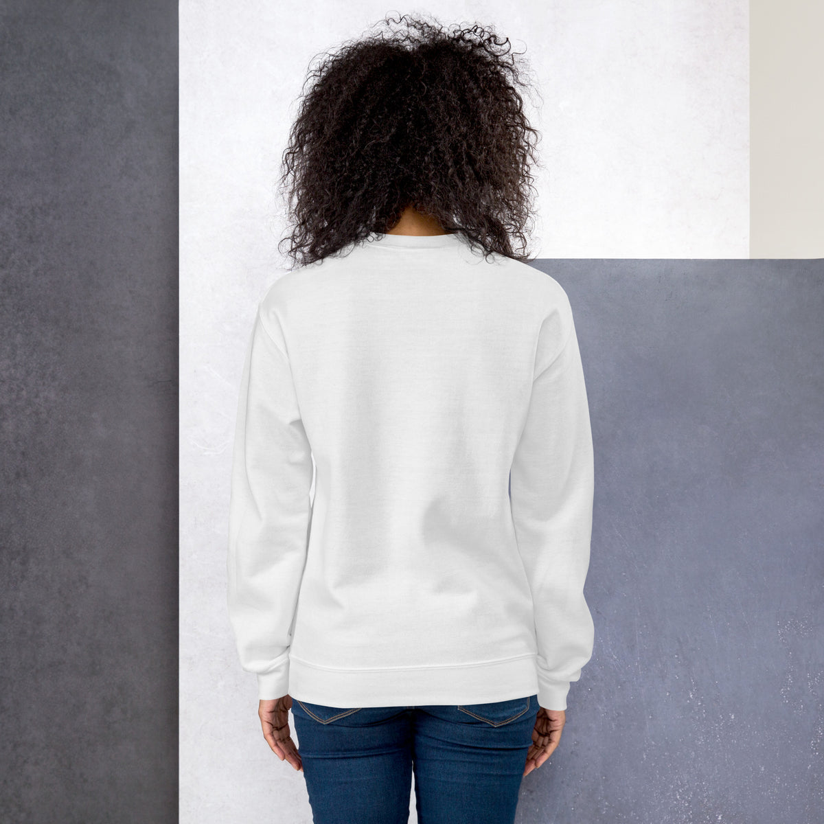 White unisex crew-neck sweatshirt with graphic print from Tristan's Outlet, shown from the back.
