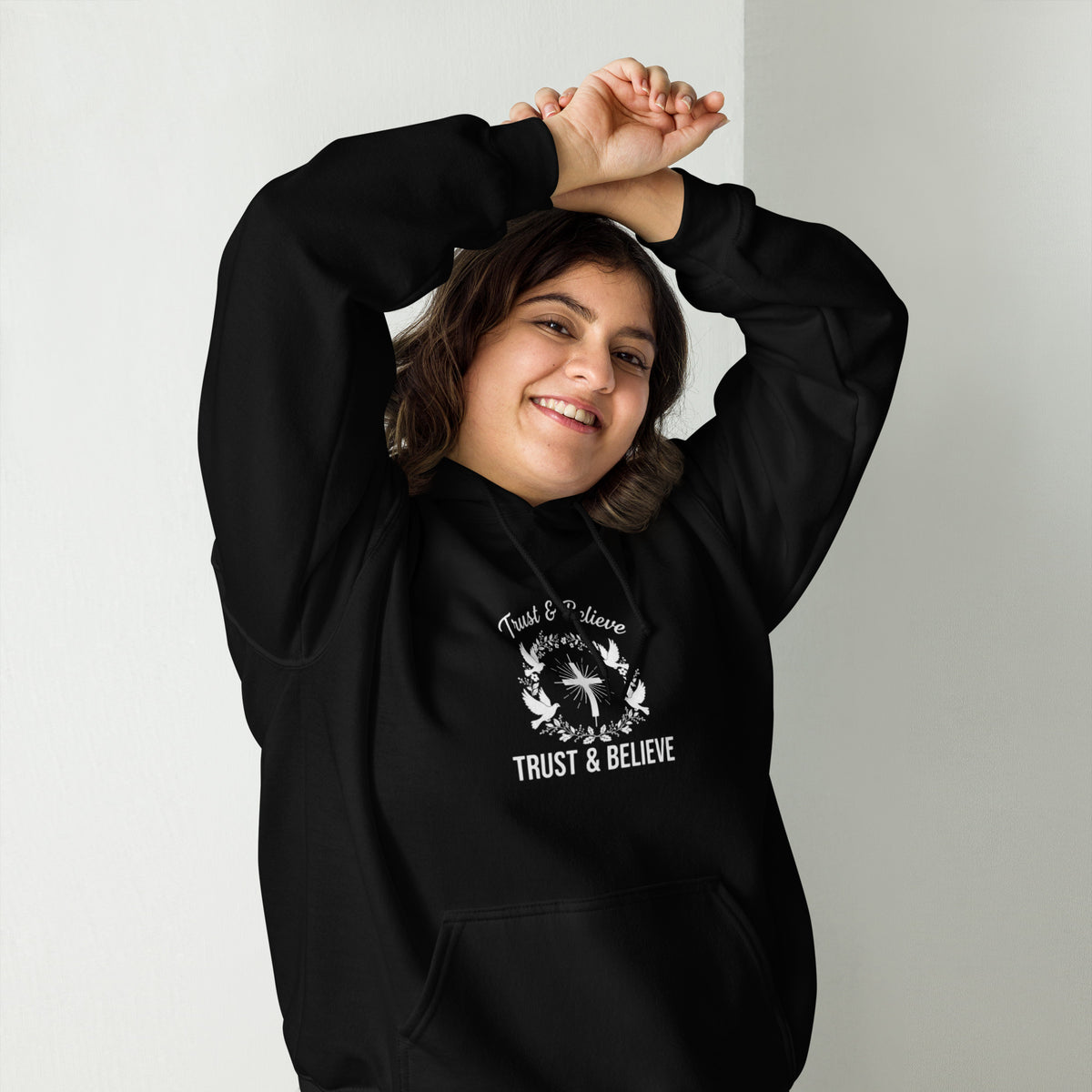Black Trust & Believe unisex hoodie by Tristan's Outlet, front view showing style and comfortable design.