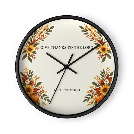 Black-framed wall clock featuring "Give Thanks" 1 Chronicles 16:34 inscription by Tristan's Outlet, with black clock hands and face.